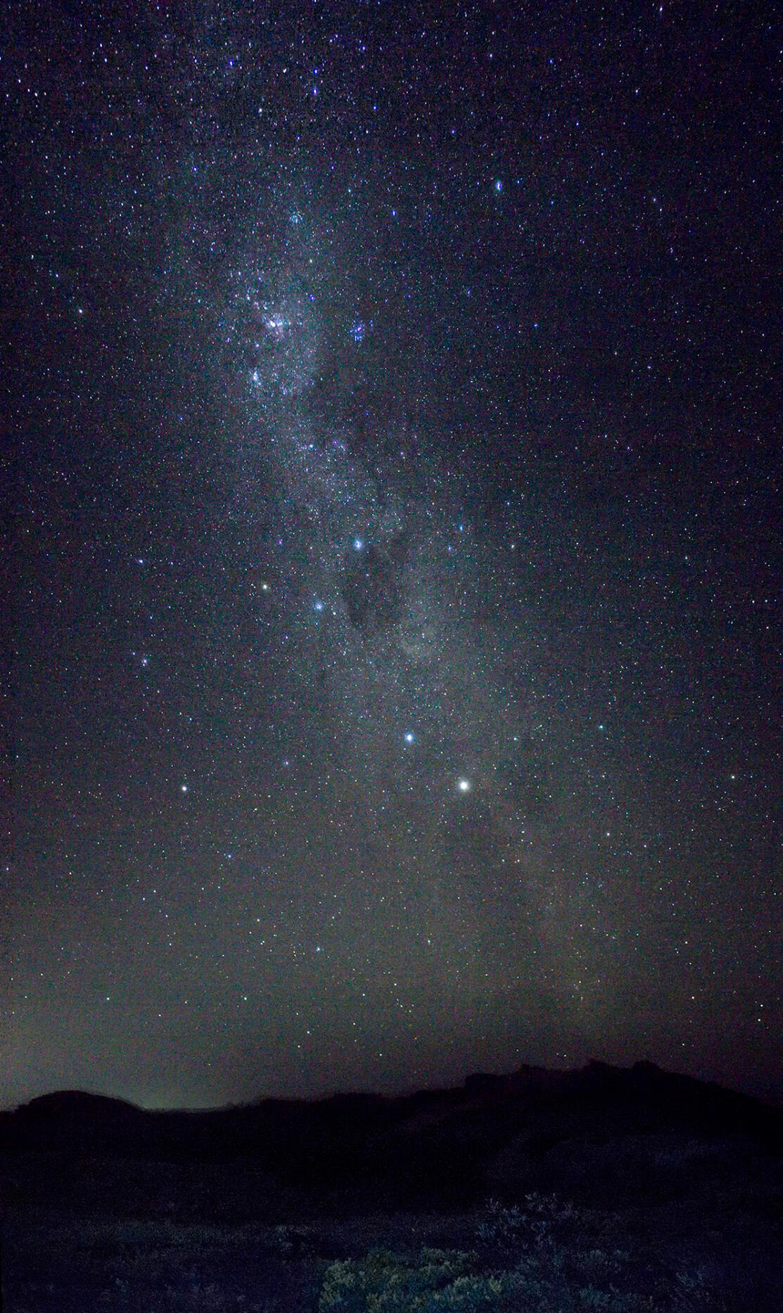 A photo of a portion of the milky way above some low mountains